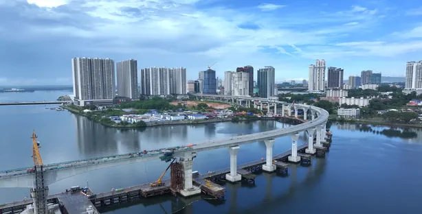 The RTS Link marine viaduct curving across the Straits of Johor towards the Johor Bahru skyline