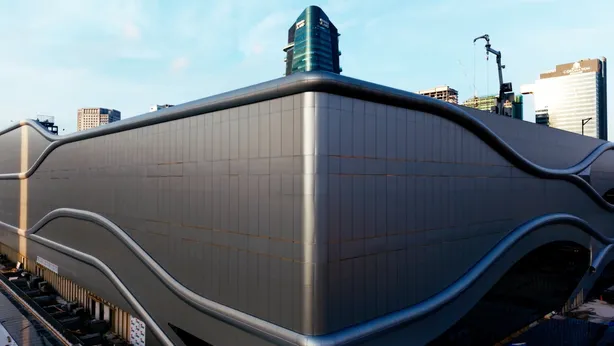 The sculpted metal roof of Bukit Chagar station in close-up, its curved surface running the length of the building