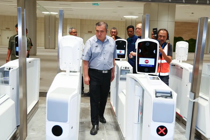 Passengers at the immigration gates with passports and QR codes