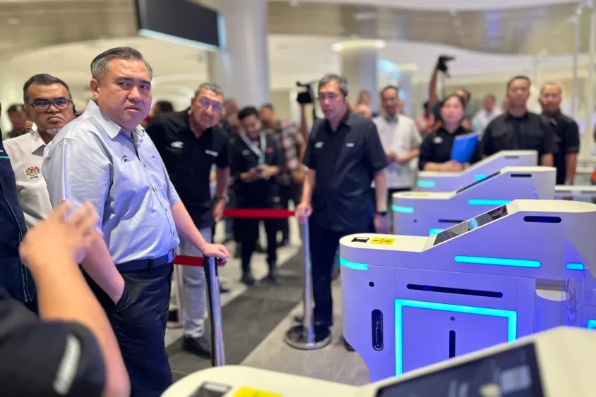 Passengers clearing the automated immigration lanes at an RTS Link station