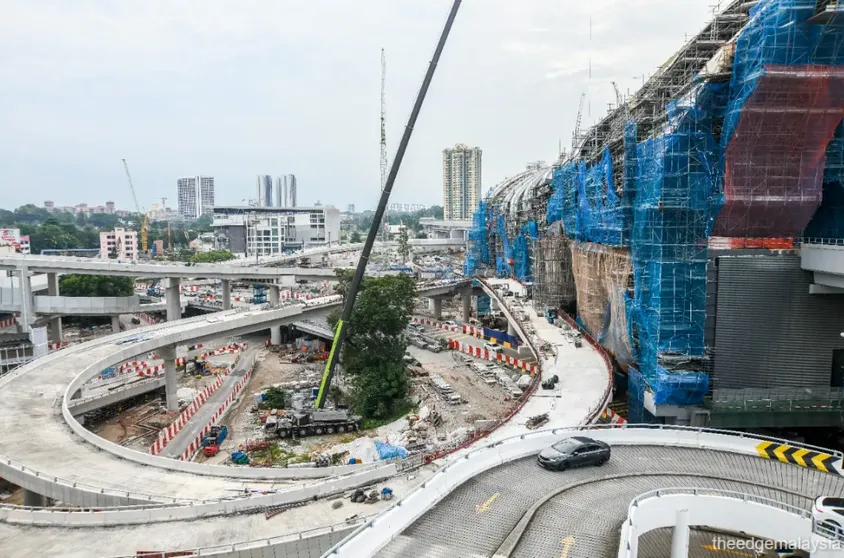 Construction under way at the RTS Link Bukit Chagar station, wrapped in scaffolding