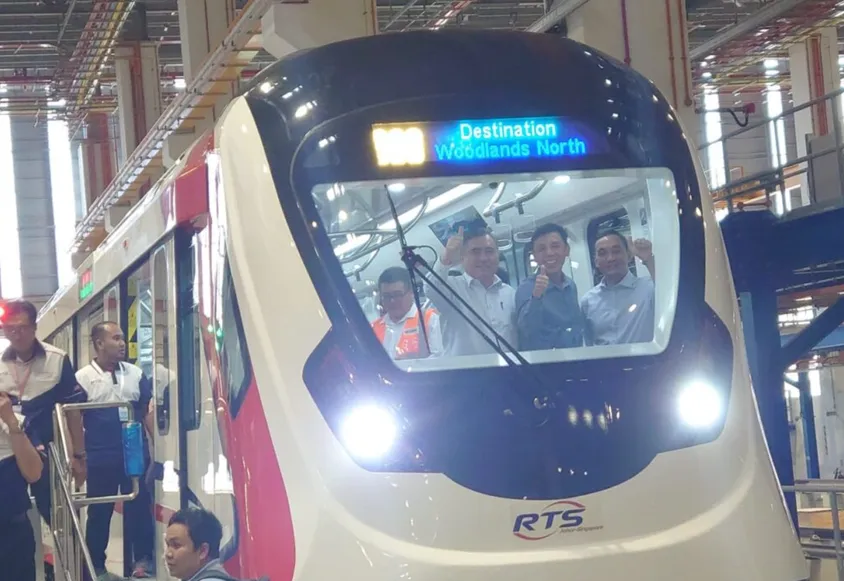 Officials posing aboard an RTS Link train during a media preview